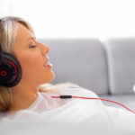 Relaxed woman listening to music on headphones